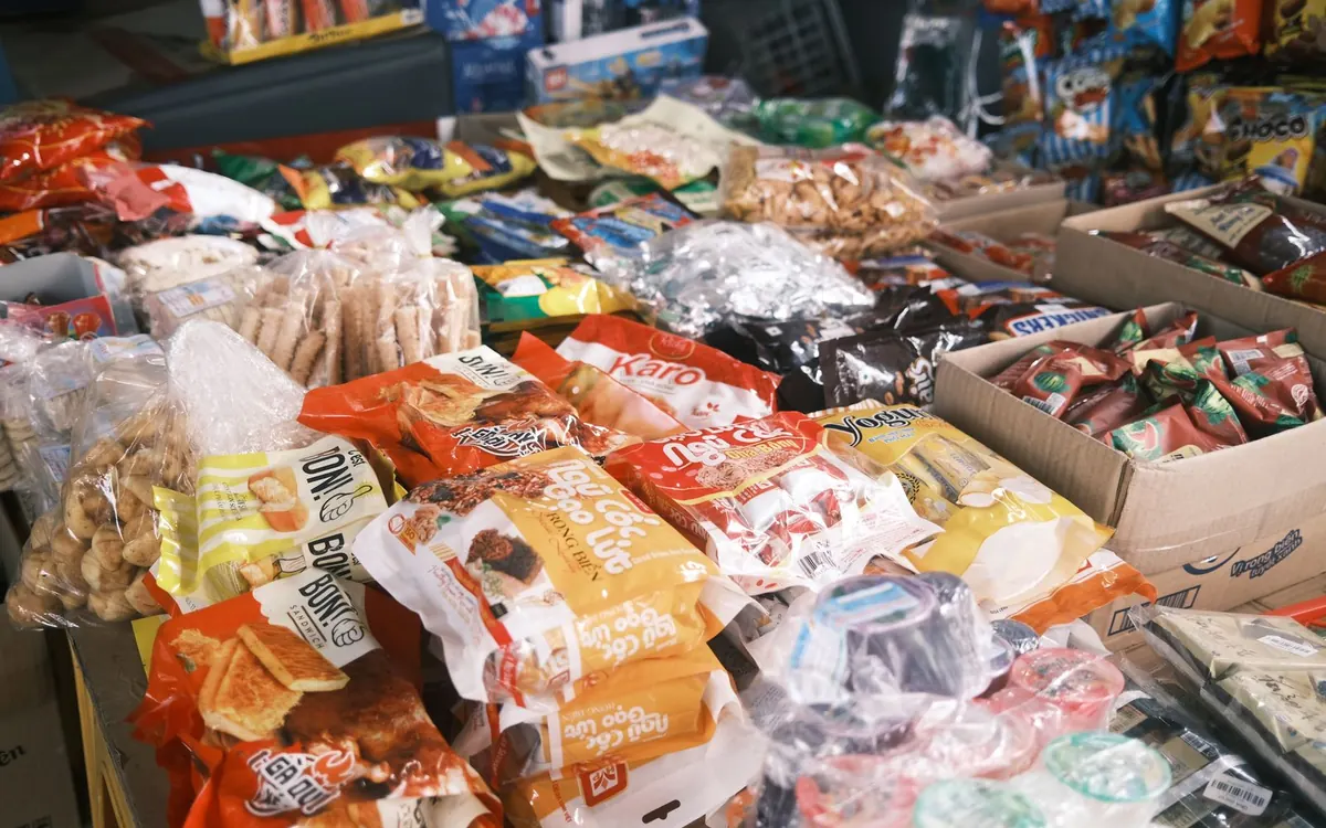 Packaged snacks, sweets and biscuits displayed at a local shop.
