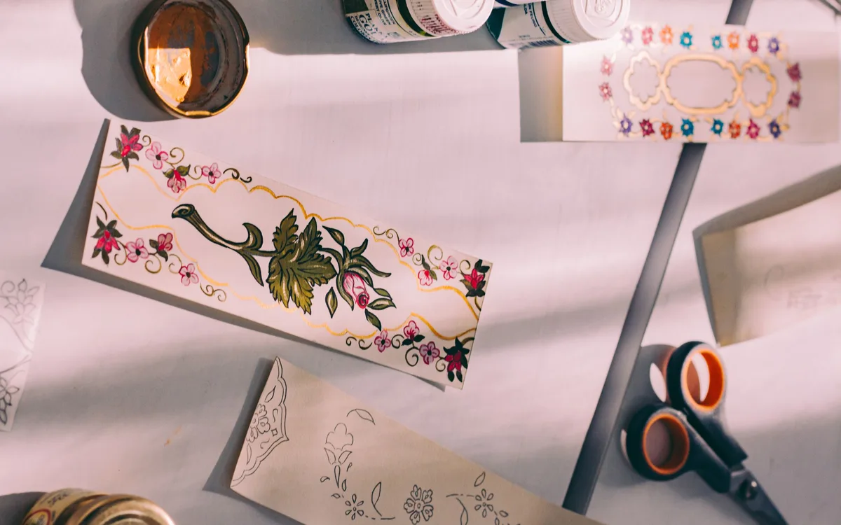 Handmade decorated bookmarks arranged with drawing supplies.