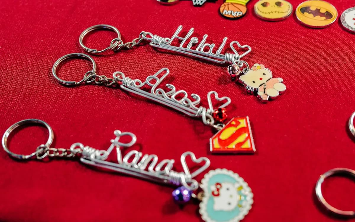 Personalised name keyrings with heart details and colourful charms.