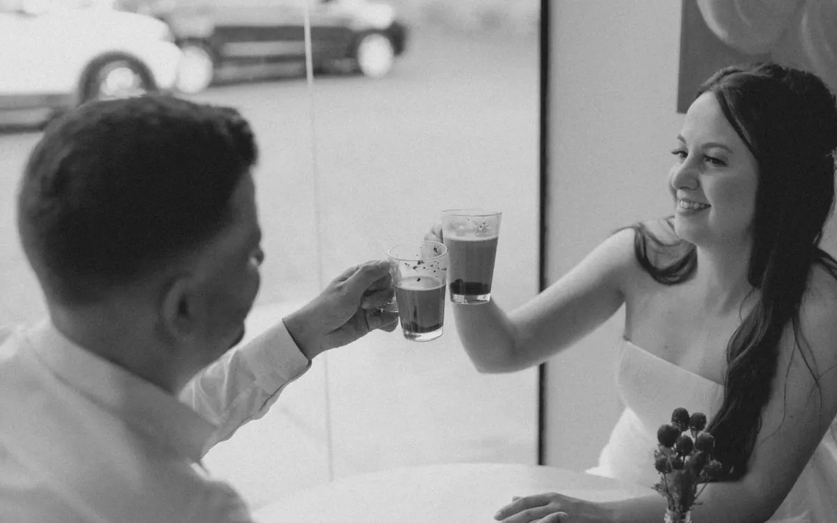 A couple sharing coffee and conversation at a cafe.