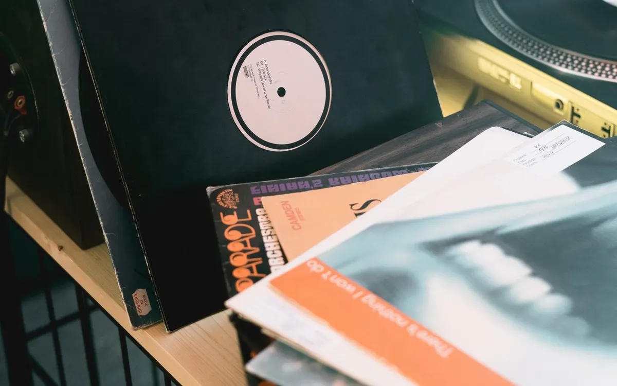 Vinyl records beside a turntable and microphone.