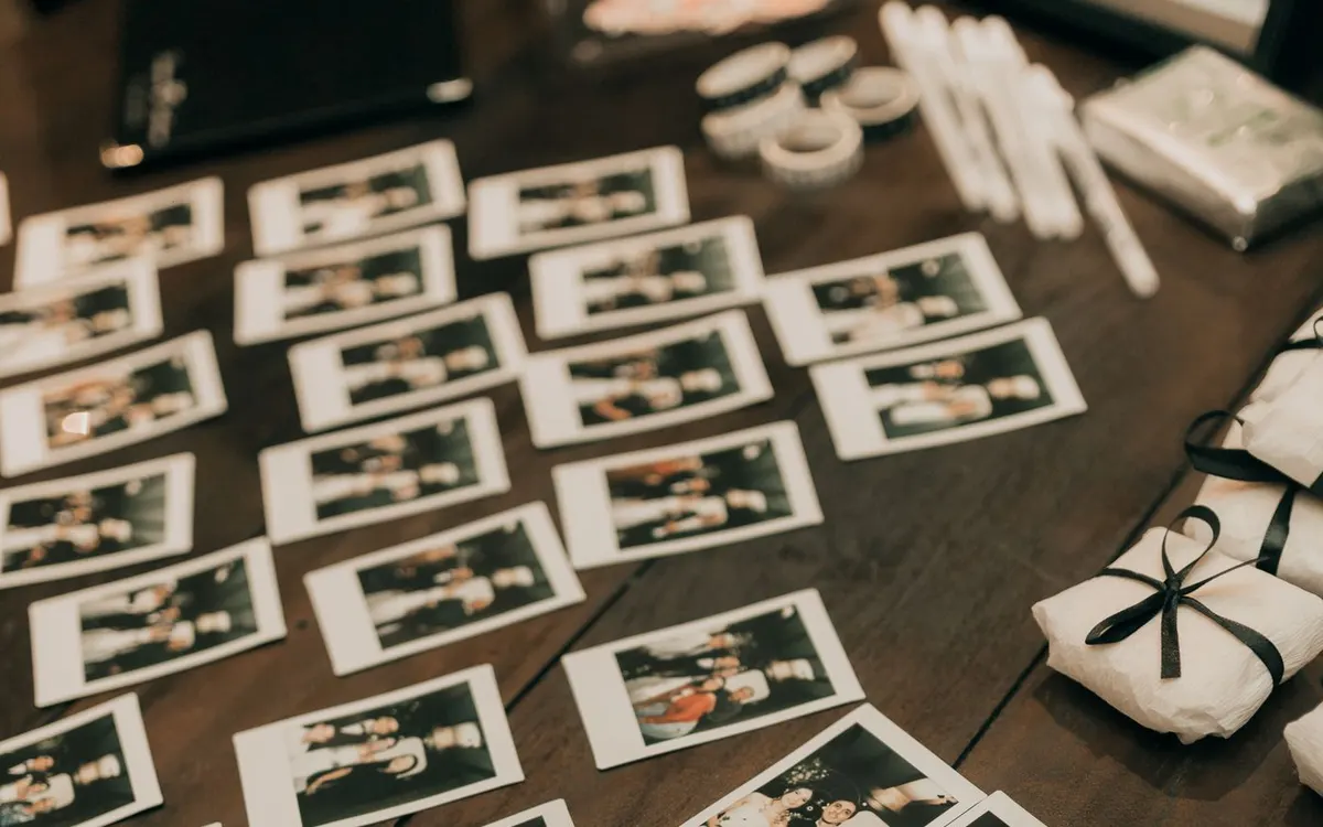 Instant photographs arranged across a wooden table.