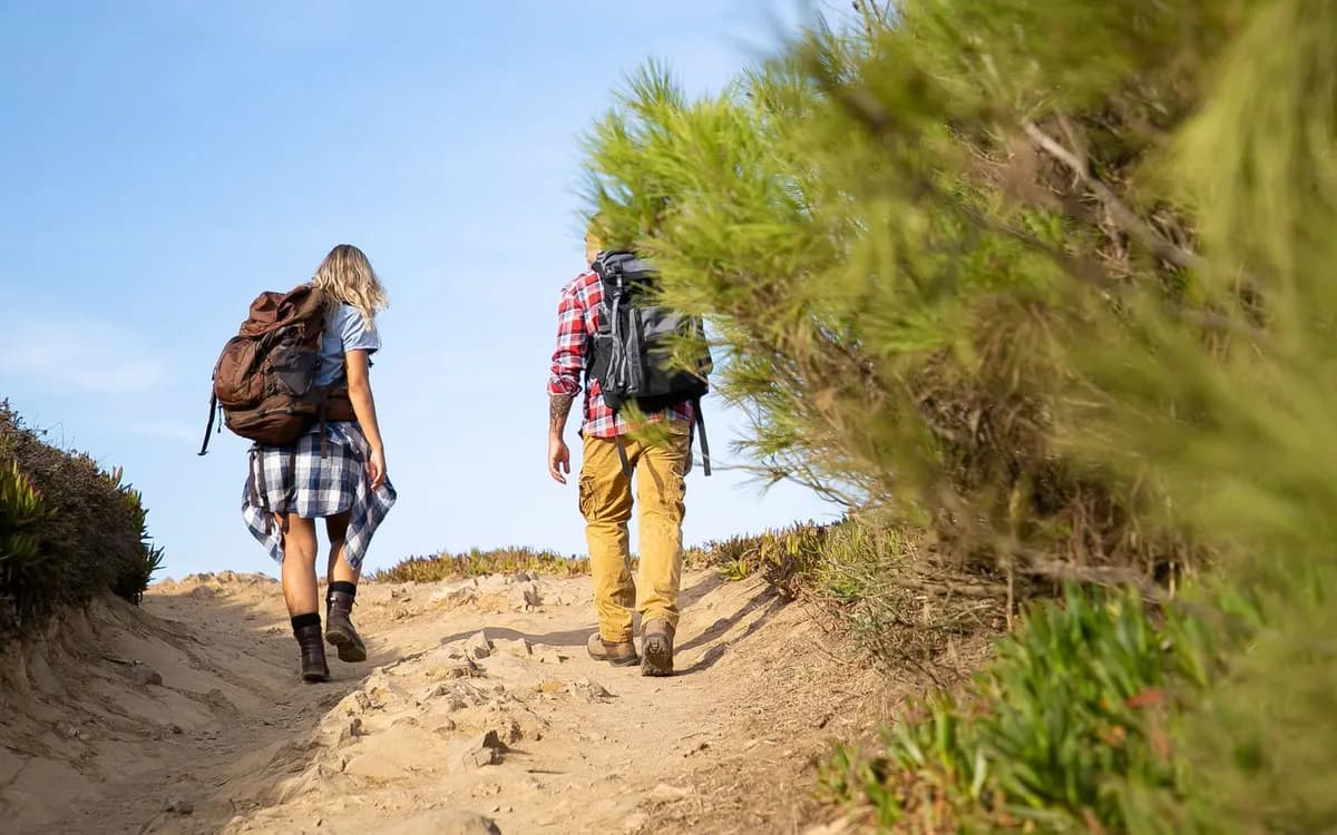 A couple walking along a scenic hiking trail.