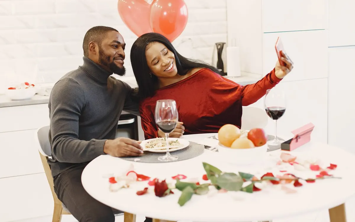 A couple taking a selfie during a celebratory dinner.